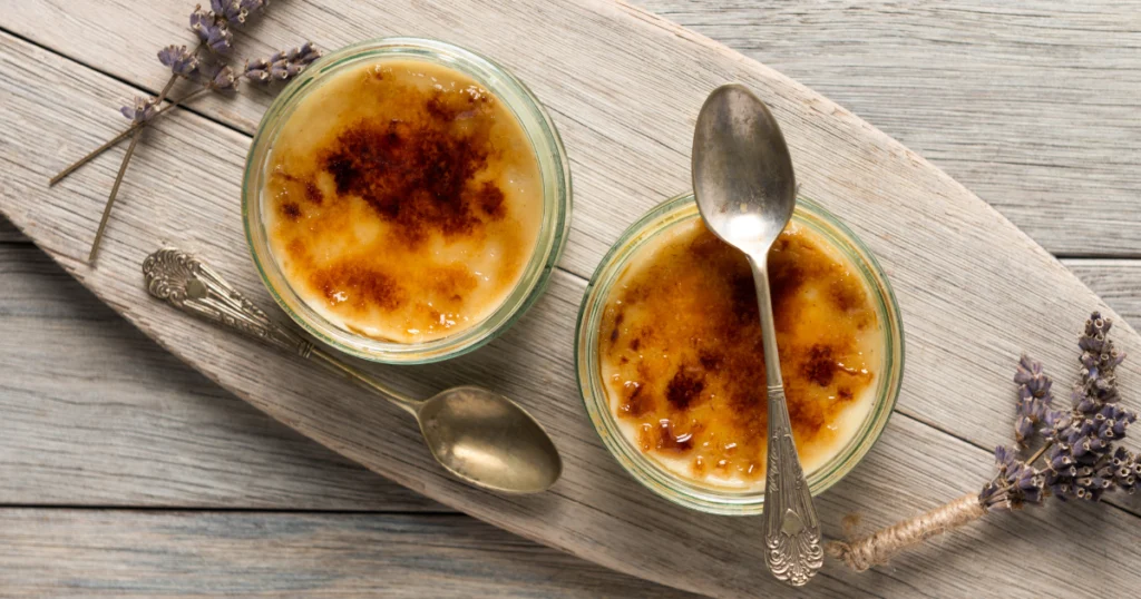 A golden-brown crab brulee garnished with fresh herbs and served in a ramekin.